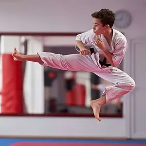teenager doing a flying kick